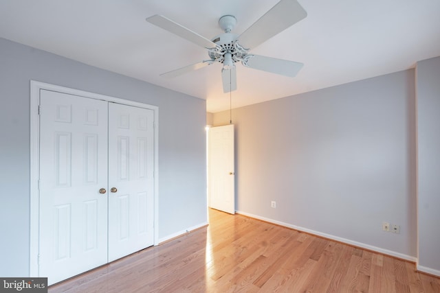 unfurnished bedroom with a closet, ceiling fan, and light wood-type flooring