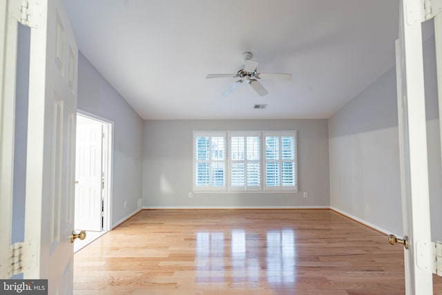 spare room featuring light hardwood / wood-style flooring and ceiling fan