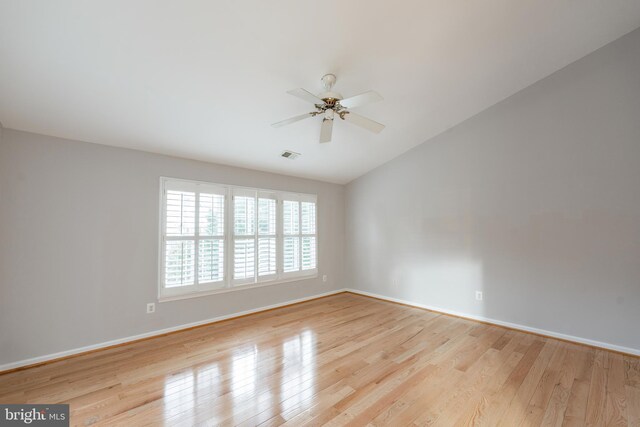 spare room with light hardwood / wood-style flooring, ceiling fan, and vaulted ceiling