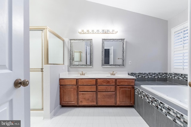 bathroom with tile patterned floors, vanity, and plus walk in shower