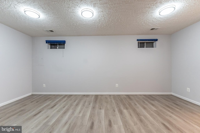 basement with a textured ceiling and light wood-type flooring