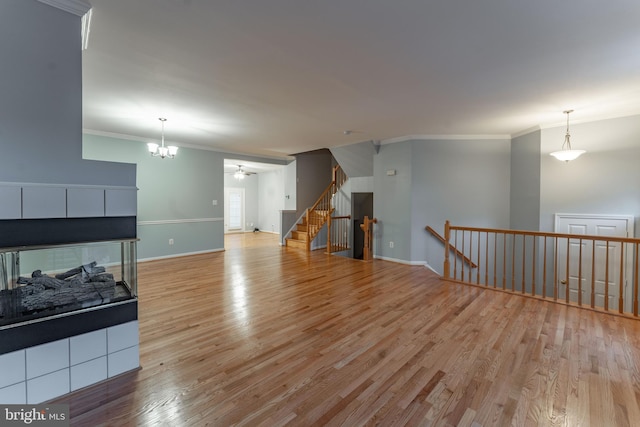 living room with ornamental molding and light hardwood / wood-style flooring