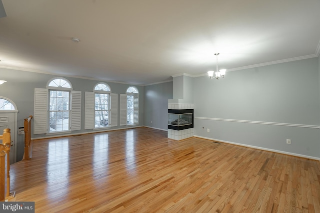 unfurnished living room with crown molding, light wood-type flooring, and a multi sided fireplace