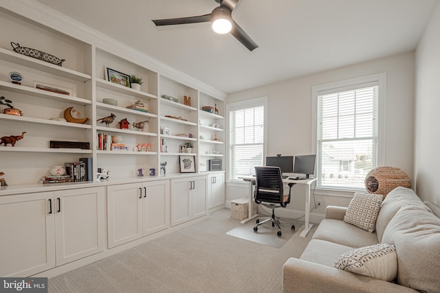 office space with light colored carpet and ceiling fan