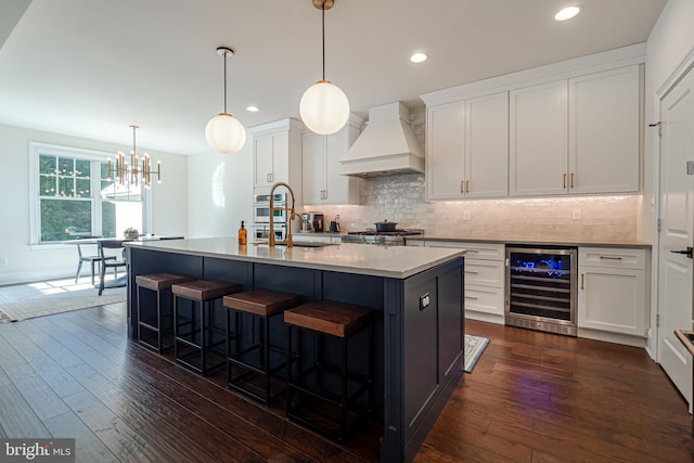 kitchen with beverage cooler, dark wood-style floors, custom exhaust hood, and white cabinets