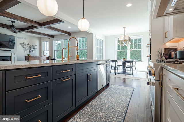 kitchen featuring dark wood-style flooring, a sink, a ceiling fan, appliances with stainless steel finishes, and beamed ceiling