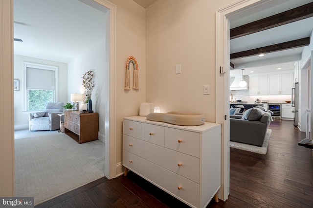 hall with beverage cooler, baseboards, beamed ceiling, and dark wood-style flooring