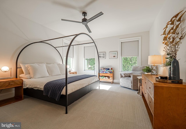 bedroom featuring light carpet and a ceiling fan