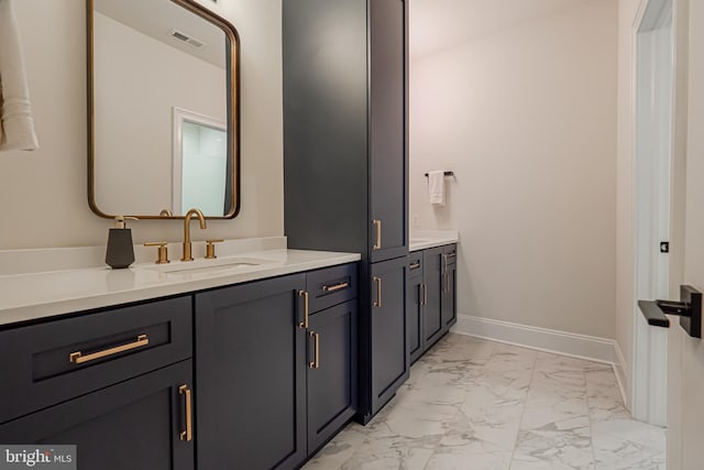 bathroom featuring marble finish floor, visible vents, baseboards, and vanity