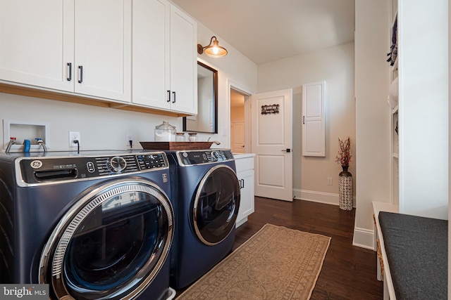 washroom featuring dark wood-type flooring, cabinet space, independent washer and dryer, and baseboards