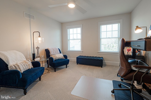 office space with ceiling fan, carpet, visible vents, and baseboards