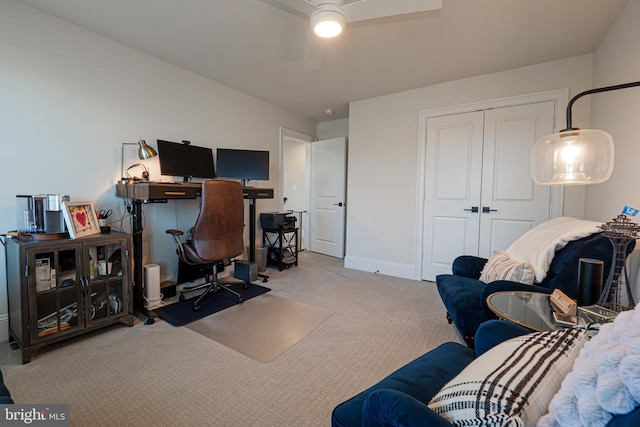 office space with carpet, ceiling fan, and baseboards