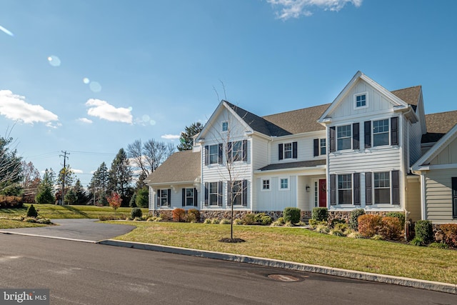 view of front of house featuring board and batten siding and a front yard