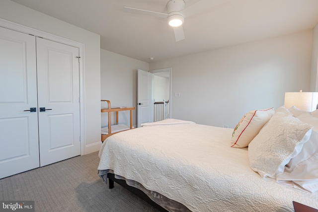 bedroom featuring carpet floors, a closet, baseboards, and a ceiling fan