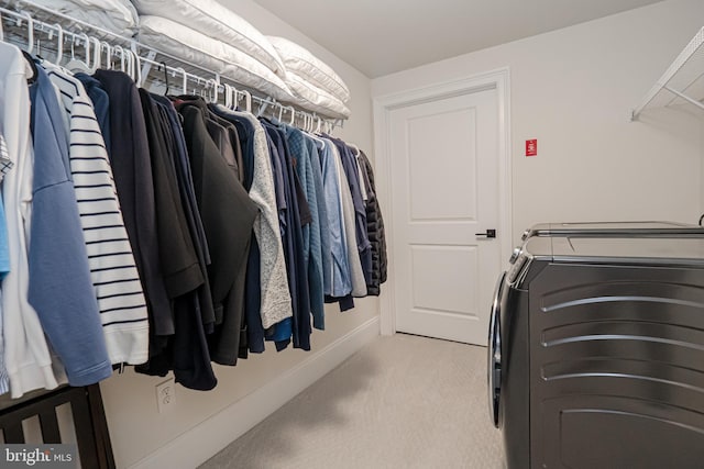 spacious closet featuring carpet floors and washer and clothes dryer