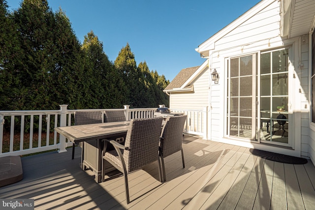 wooden terrace with outdoor dining space