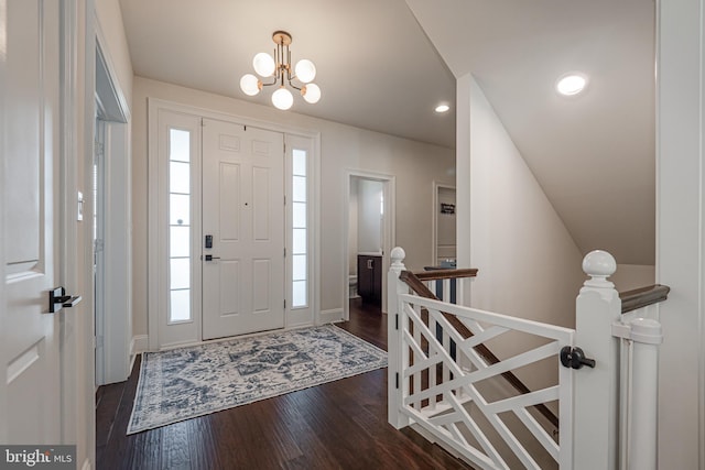 entryway with a notable chandelier, dark wood finished floors, and recessed lighting