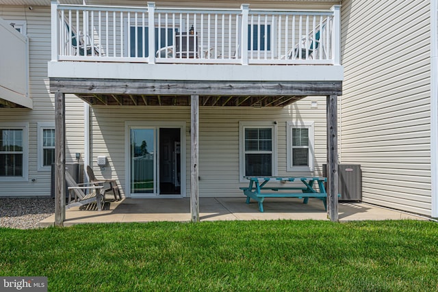 back of house with a yard and a patio