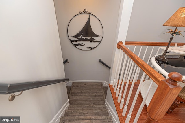 stairs featuring hardwood / wood-style floors