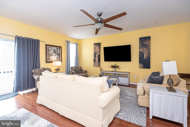 living room featuring hardwood / wood-style floors and ceiling fan