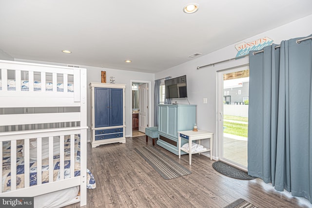 bedroom featuring access to outside and dark hardwood / wood-style flooring