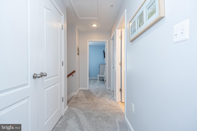 hallway with light colored carpet