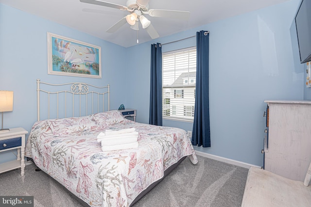 bedroom with ceiling fan and dark colored carpet