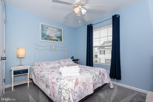 bedroom with dark carpet and ceiling fan