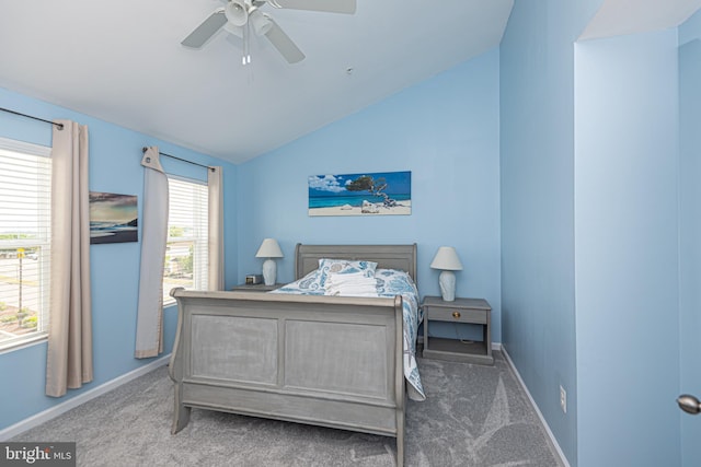 carpeted bedroom featuring lofted ceiling, multiple windows, and ceiling fan