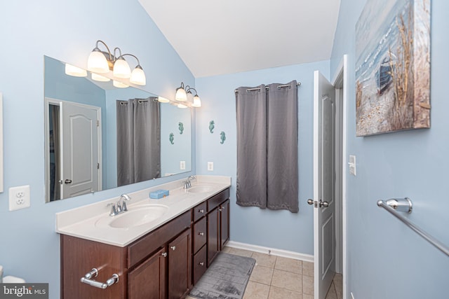 bathroom featuring vanity, tile patterned floors, and vaulted ceiling