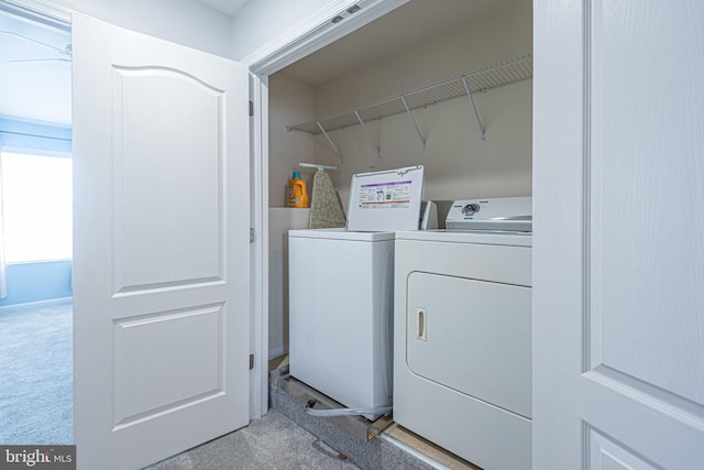 laundry room featuring washing machine and dryer and light carpet