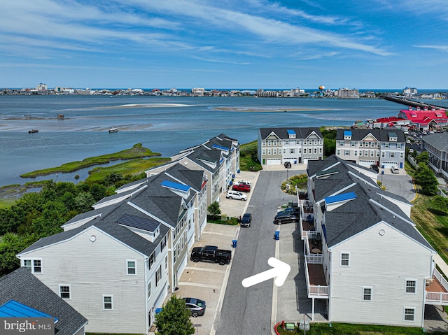 birds eye view of property with a water view