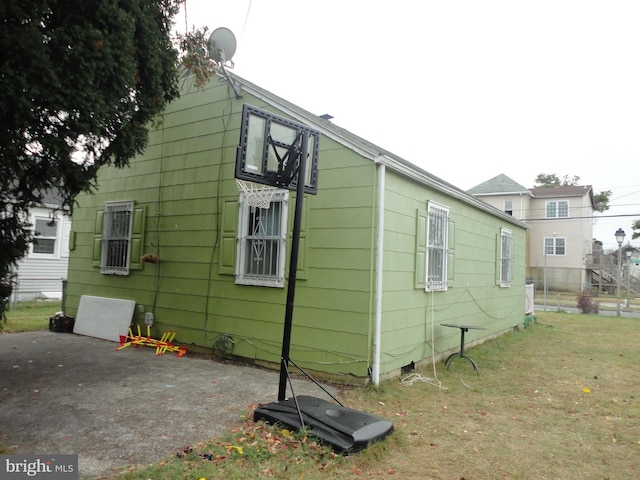 view of property exterior with a patio area and a yard