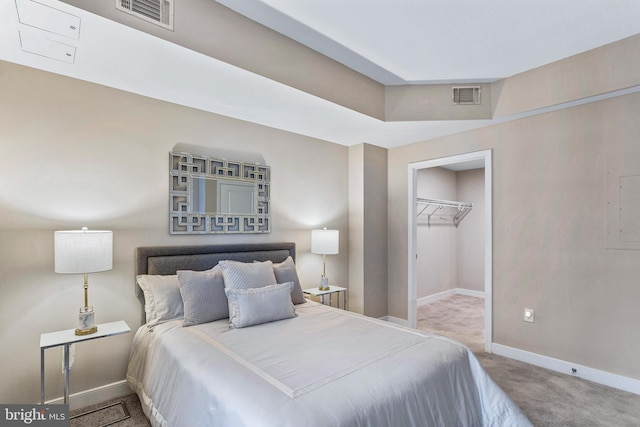 bedroom with carpet flooring, a spacious closet, and a closet