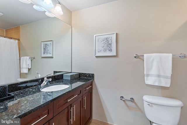 bathroom featuring vanity, toilet, and walk in shower