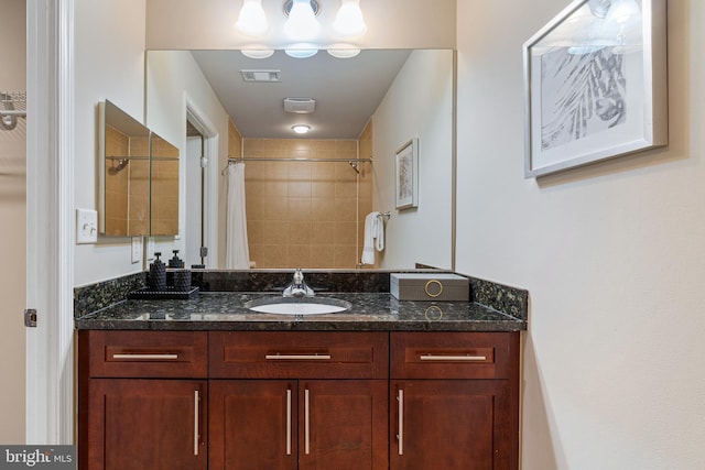 bathroom featuring vanity and curtained shower