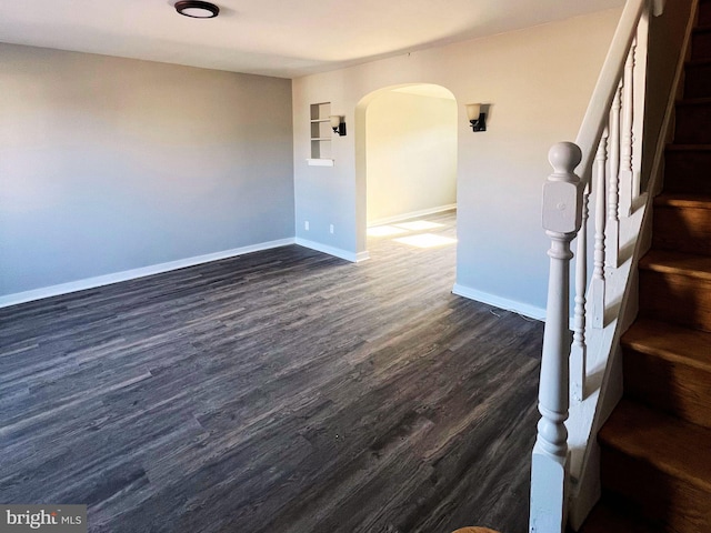 empty room with dark wood-type flooring