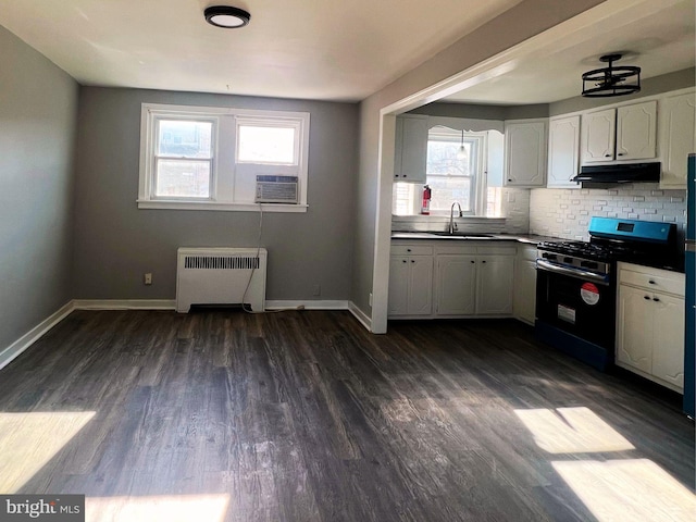 kitchen featuring white cabinets, tasteful backsplash, radiator heating unit, dark hardwood / wood-style floors, and gas range