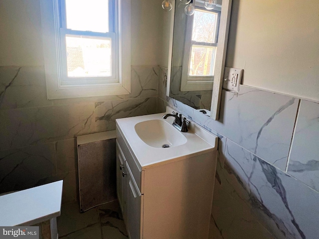 bathroom with tile walls and vanity