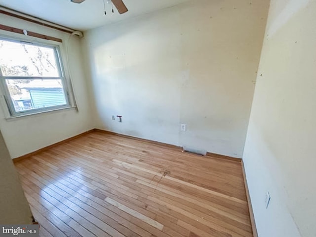 spare room with light wood-type flooring and ceiling fan