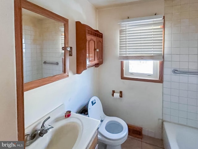 bathroom with toilet, vanity, tile patterned floors, and a bathtub