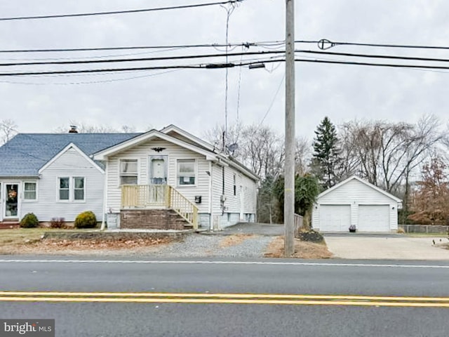 view of front of home with a garage and an outdoor structure