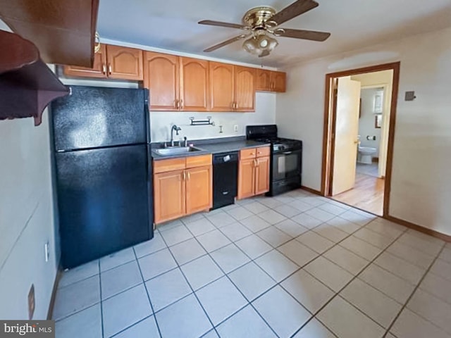 kitchen with black appliances, ceiling fan, light tile patterned flooring, and sink