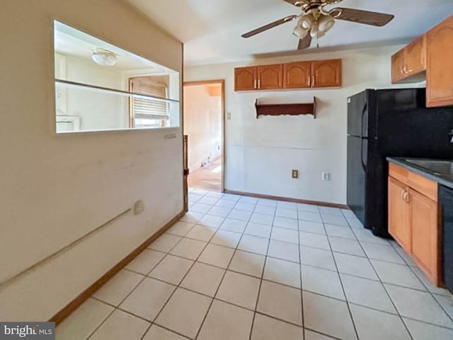 kitchen featuring light tile patterned flooring, ceiling fan, and black appliances