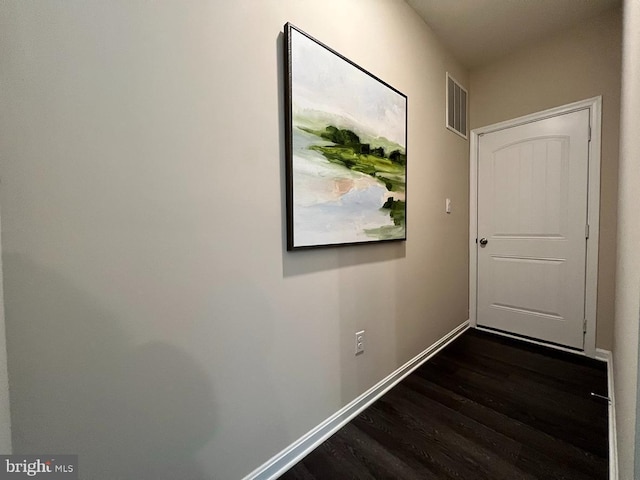 corridor featuring dark hardwood / wood-style flooring