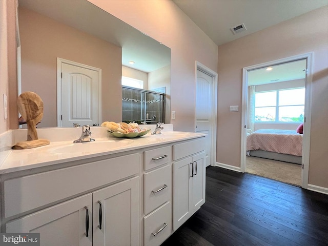 bathroom featuring hardwood / wood-style flooring, an enclosed shower, and vanity