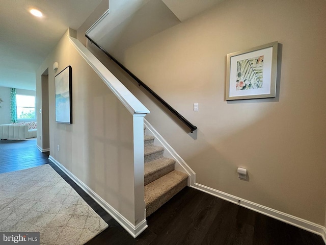 stairway featuring hardwood / wood-style flooring