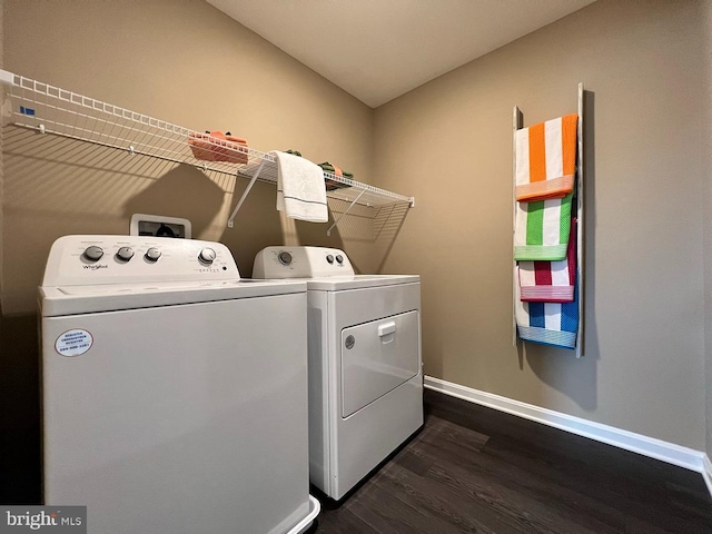 clothes washing area featuring separate washer and dryer and dark wood-type flooring