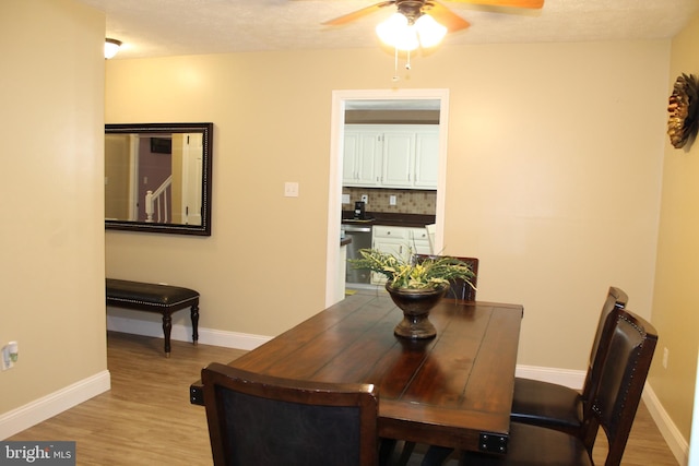 dining space with ceiling fan and light hardwood / wood-style floors