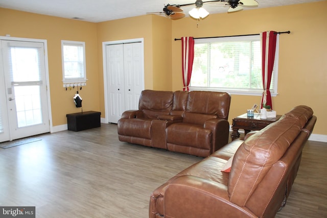 living room featuring ceiling fan and hardwood / wood-style flooring